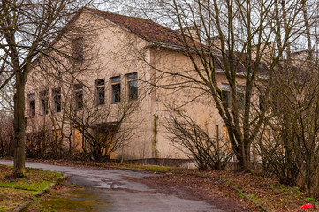 The road to the big abandoned building with broken windows on Subaciaus street in Old Town of Vilnius