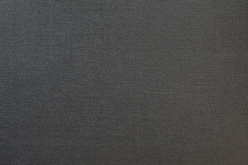 Fototapeta na wymiar Dark gray textured fabric. Close-up. Background