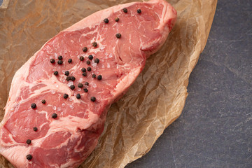 Raw New York Strip Steak on Brown Butcher Paper