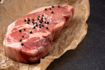 Raw New York Strip Steak on Brown Butcher Paper