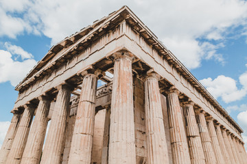 Obraz premium Temple of Hephaestus in Agora close-up, Athens, Greece. It is one of the main landmarks of Athens. Front view of the ancient Greek Temple of Hephaestus in summer. Historical sunny postcard of Athens.