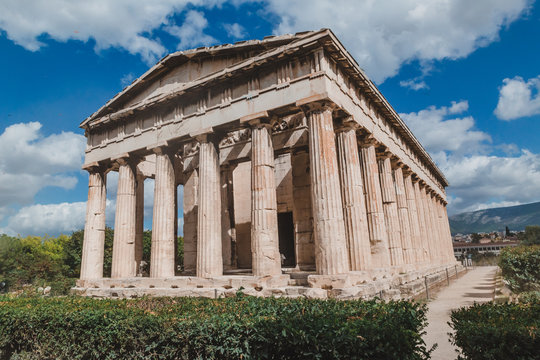 Temple of Hephaestus in Agora close-up, Athens, Greece. It is one of the main landmarks of Athens. Front view of the ancient Greek Temple of Hephaestus in summer. Historical sunny postcard of Athens.