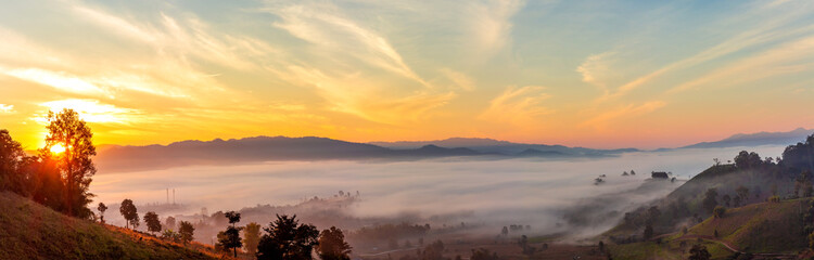 Mountain and foggy at morning time with orange sky, beautiful landscape in the thailand