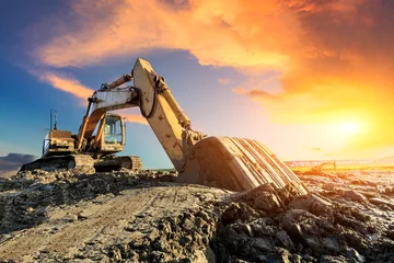 Fototapeten Excavator work on construction site at sunset © ABCDstock