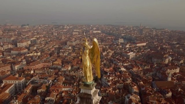 Golden statue atop campanile San Marco in Venice