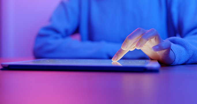 Woman use of tablet computer at home - Powered by Adobe