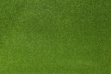 Abstract green glitter texture background. Glowing shiny paper for warp your gift box or party decoration.