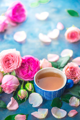 Fototapeta na wymiar Rose tea in ceramic tea cups and flower petals on a wet light background with copy space. Seasonal drink photography