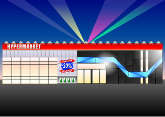 the facade of a modern hypermarket in the evening lit with bright lights