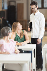 Young professor with students in classroom