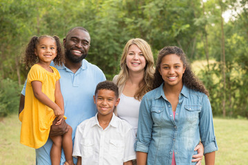 Portrait of a multi ethnic family laughing.