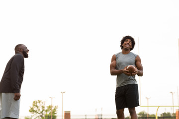 American Football coach training a young athlete.