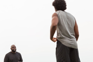 American Football coach training a young athlete.