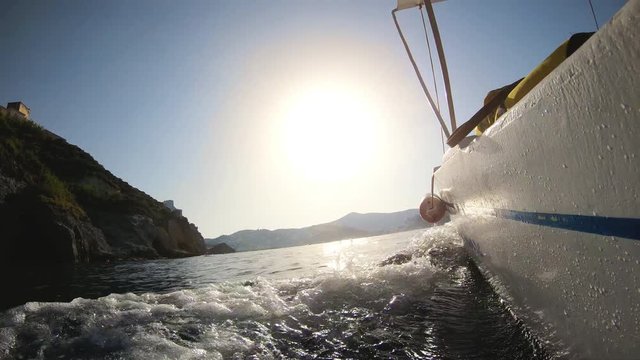 Motor boat breaking waves at sunset in the ocean action cam