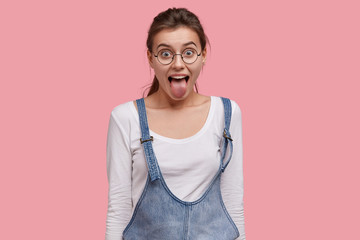 Naughty comic woman sticks out tongue, misbehaves, demonstrates her disobedience and protest, has...