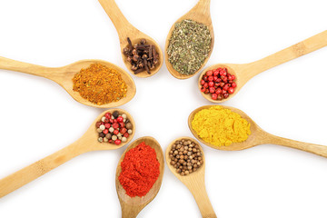 mix of spices on w isolated on wooden spoon a white background. Top view. Flat lay. Set or collection