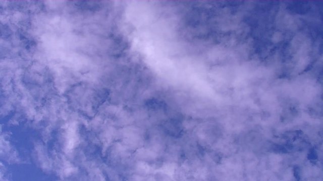 Moving clouds in the deep blue sky