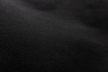 Black fabric texture background. Detail of canvas textile material.