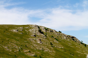 Fototapeta na wymiar Photo of nature - beautiful petrous mountain slope with bright blue sky