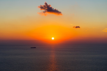 Greece, Zakynthos, Red sunset sky reflecting on silent ocean water of ionian sea