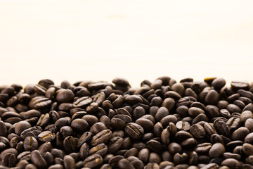 Coffee beans on wood background