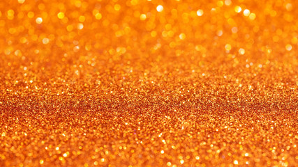 Orange glitter texture for background.