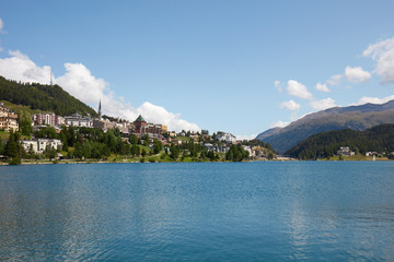 Sankt Moritz town and blue lake in a sunny summer day in Switzerland