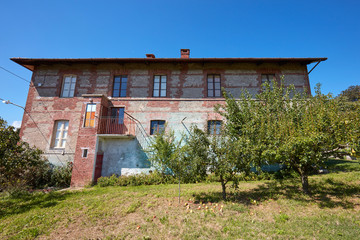 Old country house with brick walls in a sunny summer day in Italy