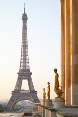 Fototapeta na wymiar Eiffel tower and Trocadero golden statues, clear summer sunrise in Paris, France