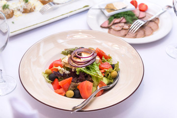 vegetable salad on a white plate on the table