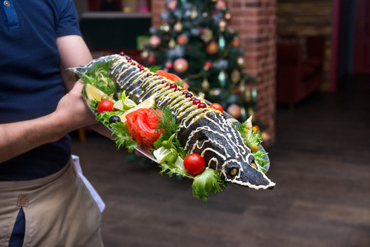 Cooked Sturgeon On A Tray In The Hands Of A Waiter, Fish Dish