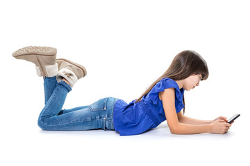 Young brunette girl lying on floor with her cell phone