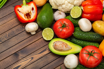Flat lay composition with assortment of fresh vegetables on wooden table. Fresh farmers garden vegetables on wooden table. Diet concept. Space for text
