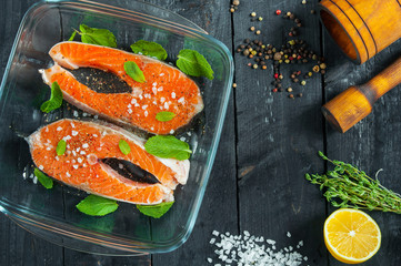 Two trout steak and ingredients for cooking.