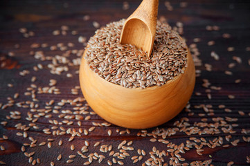Flax seeds wooden bowl on table