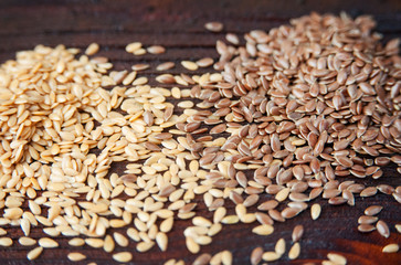 Different flax seeds on table, gold and brown.