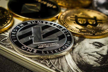 Bitcoin and other cryptocurrency coins on packs of dollars