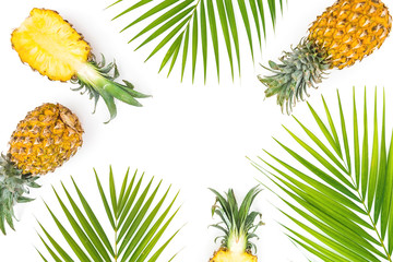 Tropical frame with pineapple and palm leaves on white background. Flat lay, top view.
