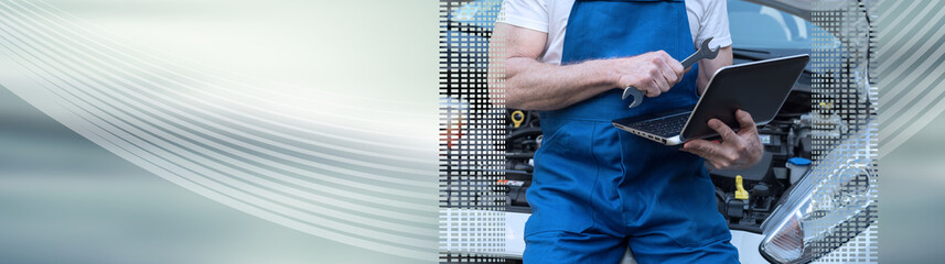 Mechanic using laptop for checking car engine. panoramic banner