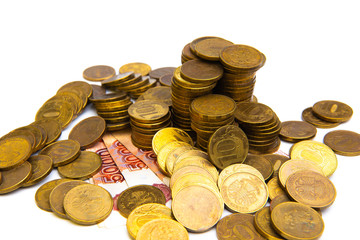 Gold coin stacks and russian ruble banknotes isolated on white