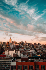 Fototapeta premium New York City Skyline, rooftop view, sunset, blue cloudy sky