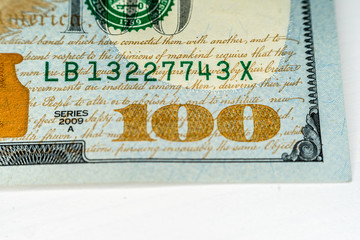 Macro shot (closeup ) of a new 100 dollar bill Series 2009 A. Serial number and yellow "100" sign