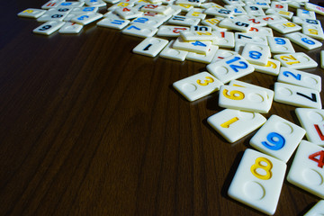 rummy pieces placed randomly on the table.