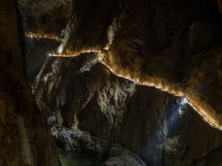 Illuminated path above the canyon in Skocjanske jame cave