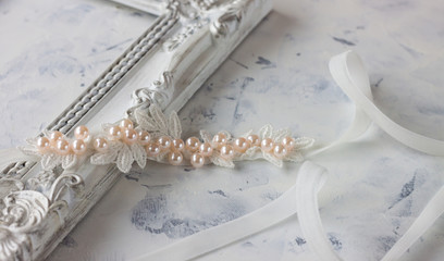 White bow with pearl. Newborn headband on white background.