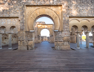 Fototapeta na wymiar Arab arches in the ruins of Medina Azahara in Cordoba, Spain at sunset.