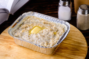 Morning Breakfast, Oatmeal porridge with butter, milk on a wooden table