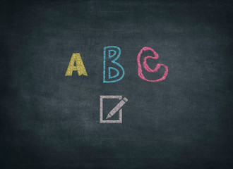Writing ABC on chalkboard or blackboard - learning at school and education
