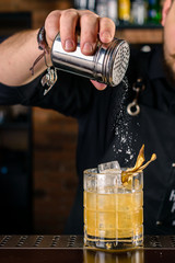 bartender at the bar making a cocktail