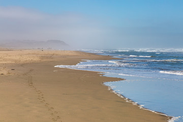 Fototapeta na wymiar A misty Ocean Beach in San Francisco, on a summer's morning